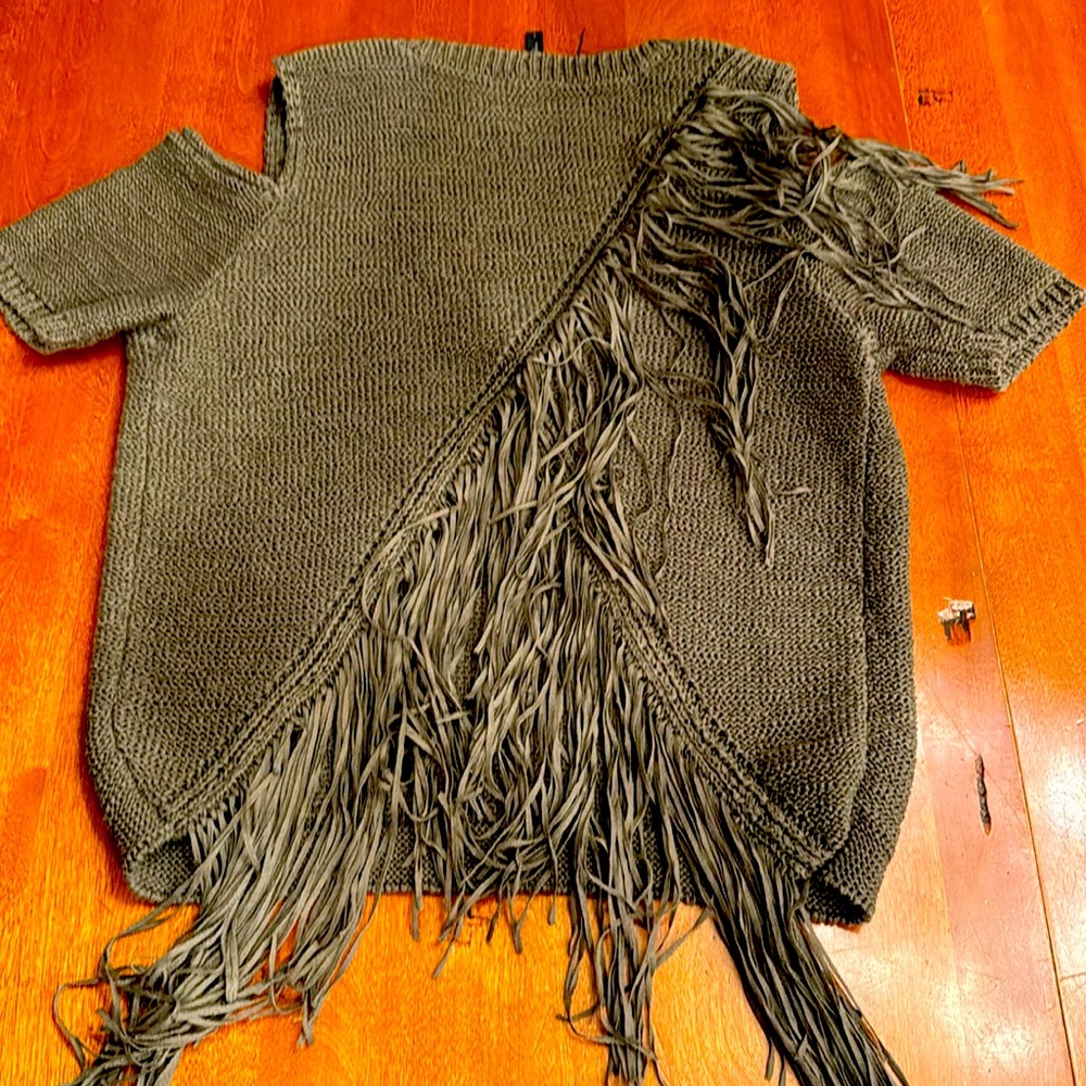 BCBG MAXAZRIA knit short sleeve sweater with fringe and open shoulders.